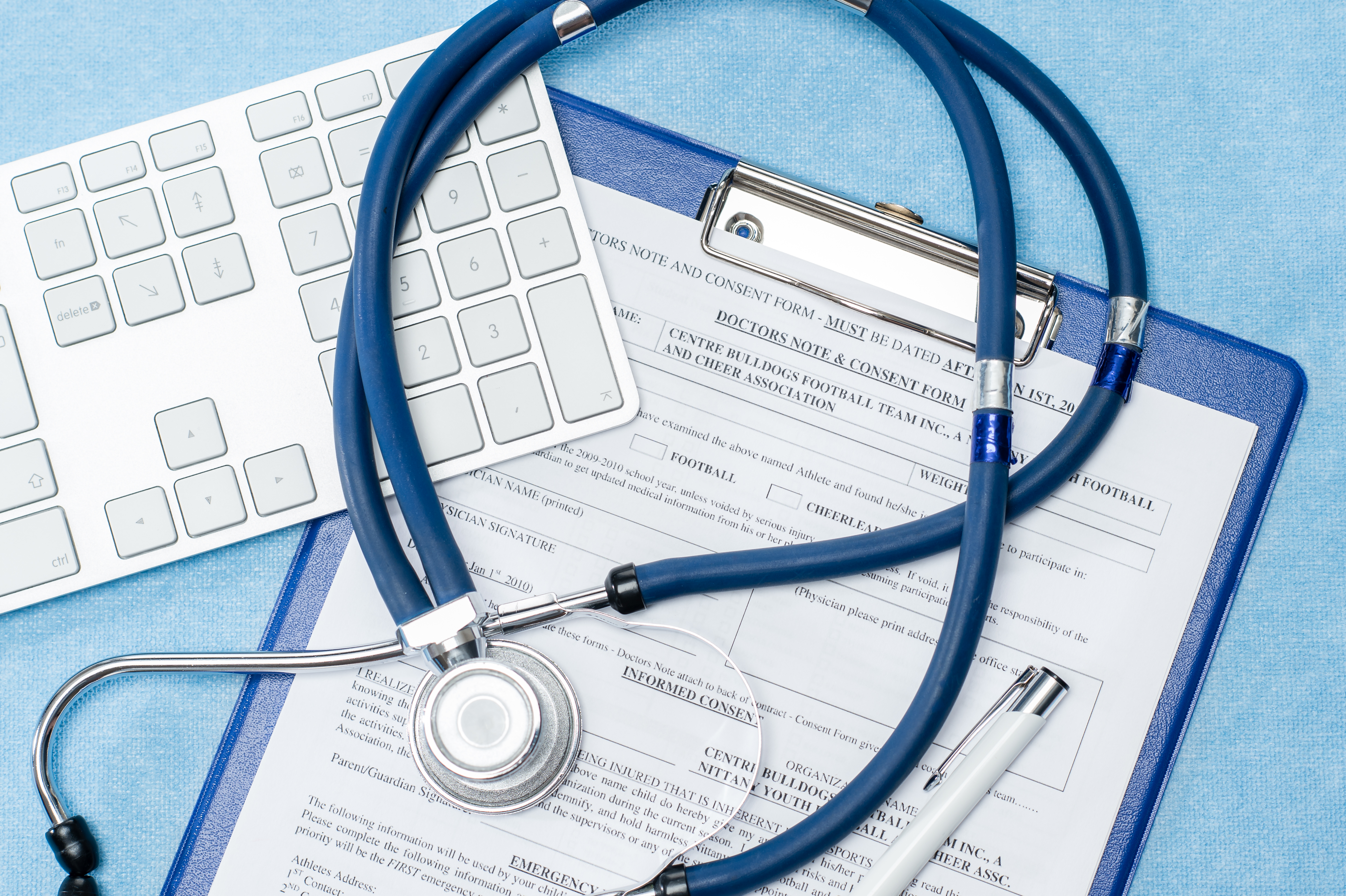Stethoscope laying over doctors emergency report