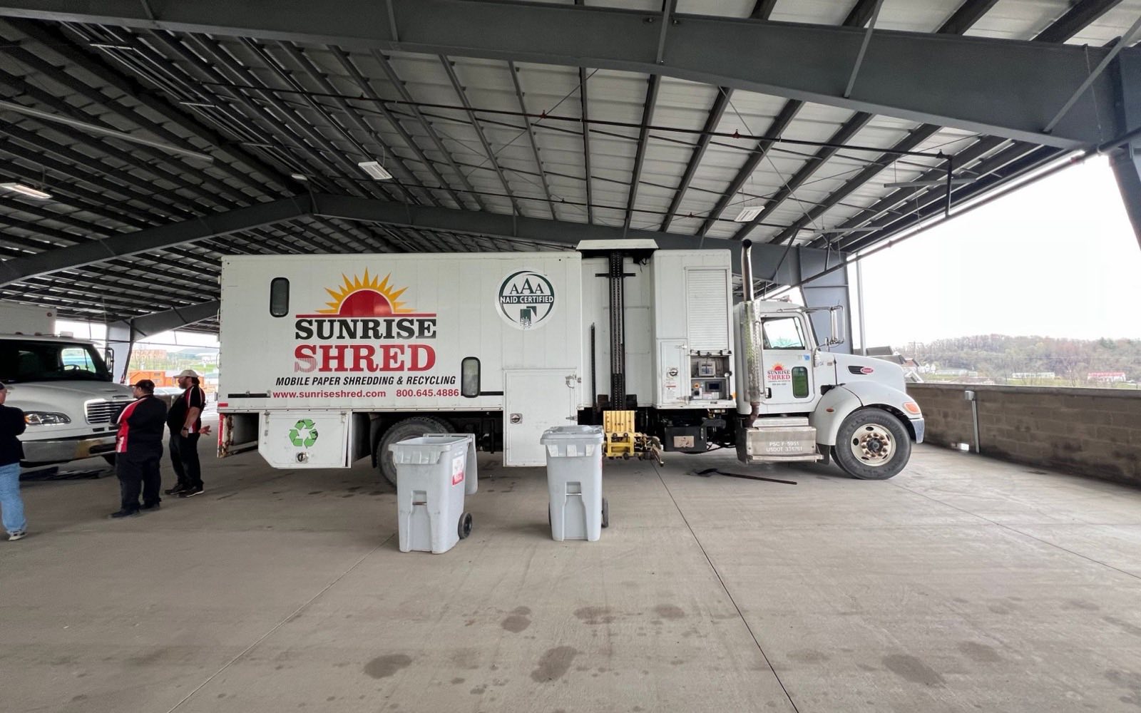Sunrise Shred mobile shredding truck under a covered pavilion